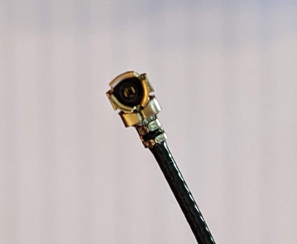 A close-up photo of the correct U.FL antenna pigtail connector for the ESP32 board.