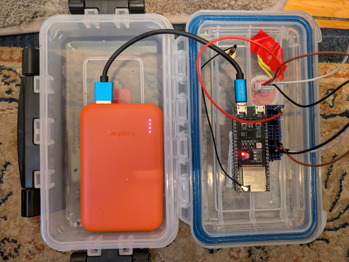 The inside of the sensor enclosure, showing the ESP32 board, USB power bank, and wiring.